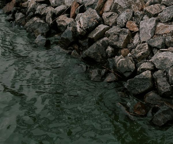 A serene natural landscape with balanced stones by a calm lake.