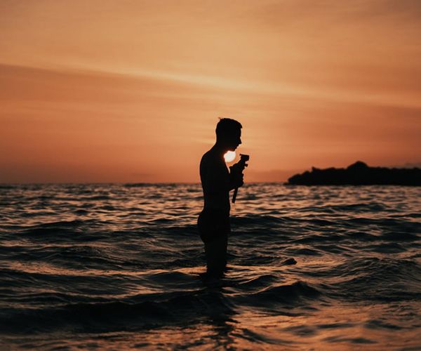 Silhouette of a person meditating against a beautiful sunset.
